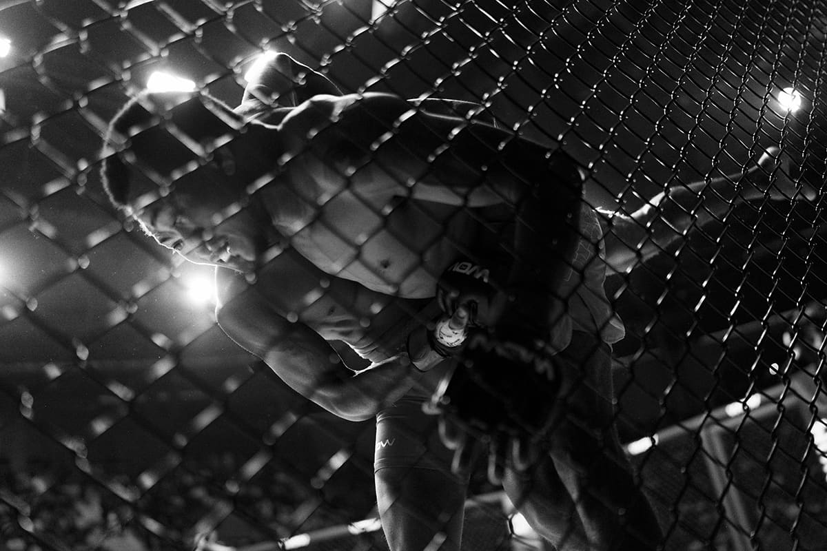 Delffy Humer grapples against the cage wall with Rafael Gemaque during a flyweight MMA bout at WOW 27 in Madrid, Spain.