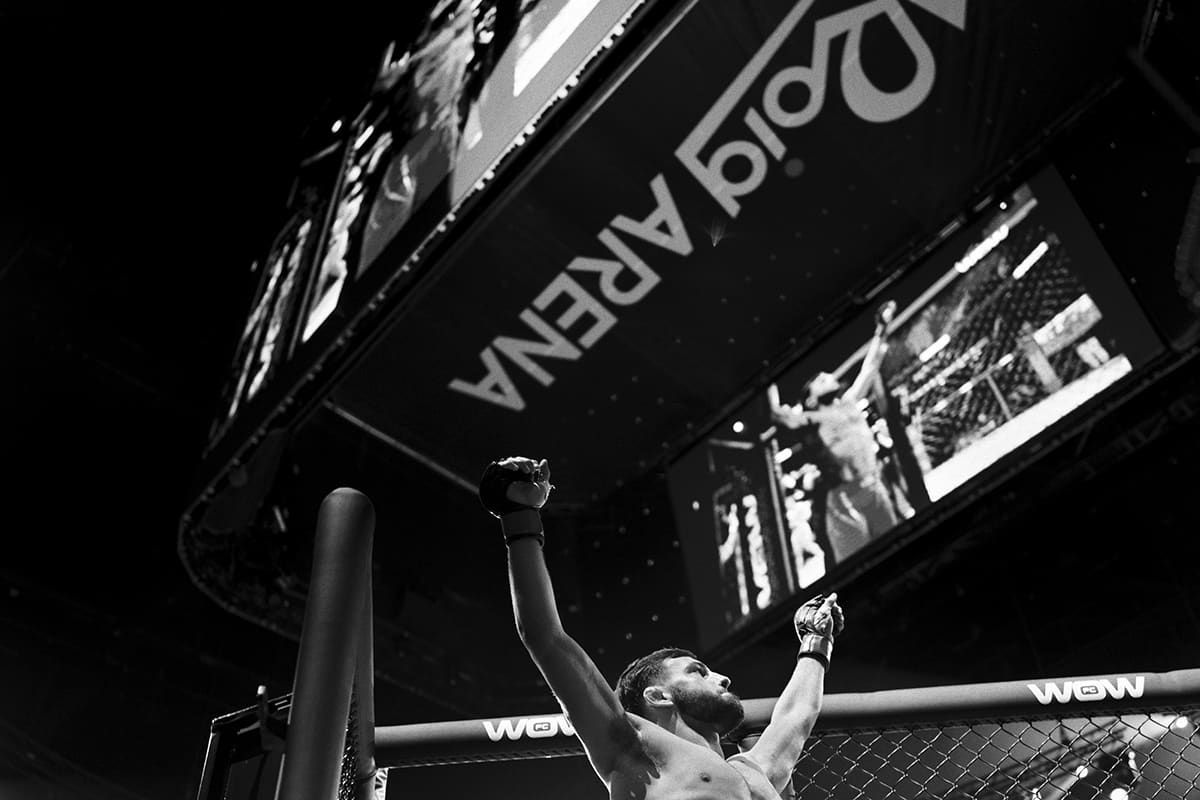 Levi Batchelor celebrates his submission victory over Kakha Kortkhonjia after a bantamweight MMA bout at Roig Arena in Valencia.