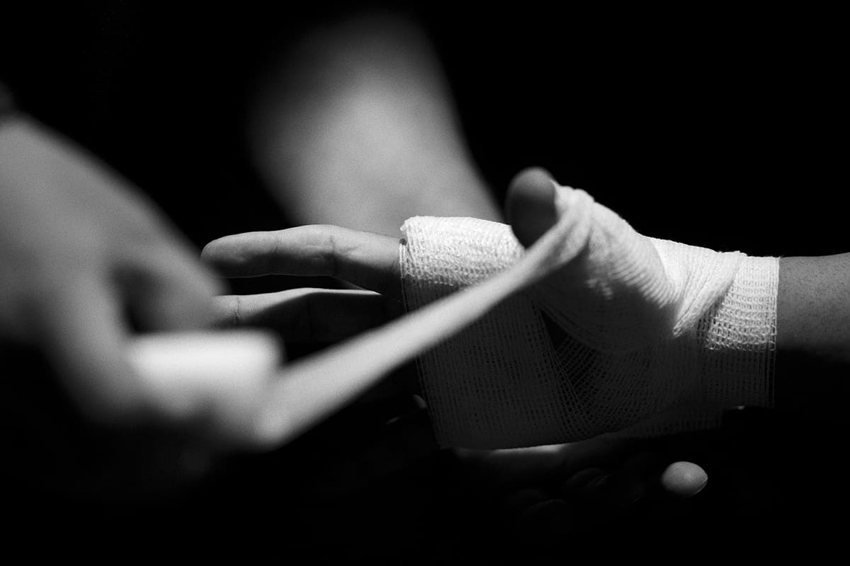 A fighter gets his hands wrapped backstage before competing in a mixed martial arts MMA event in Spain.