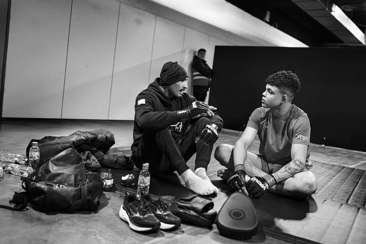 Nicolas Santos talks with his team before entering the ring for a WOW 27 mixed martial arts bout in Madrid.