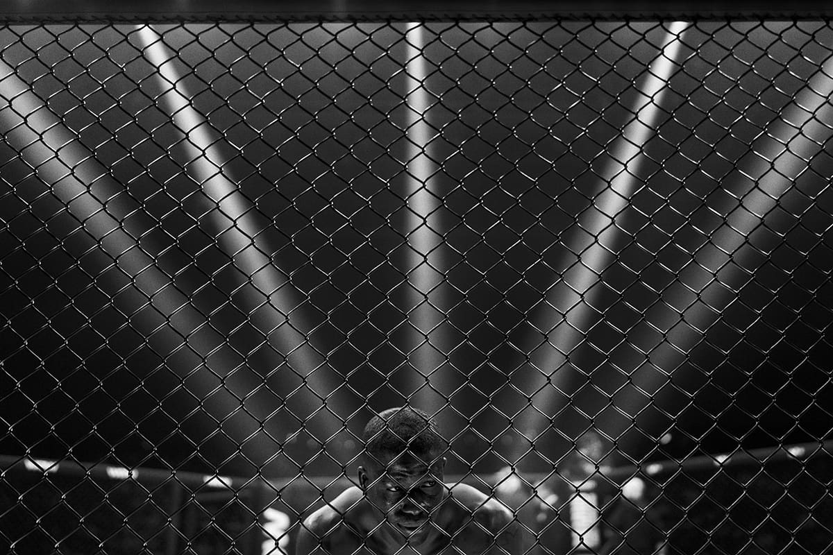 Pedro Magalhaes celebrates his rapid knockout victory inside the cage at an MMA event in Bilbao.