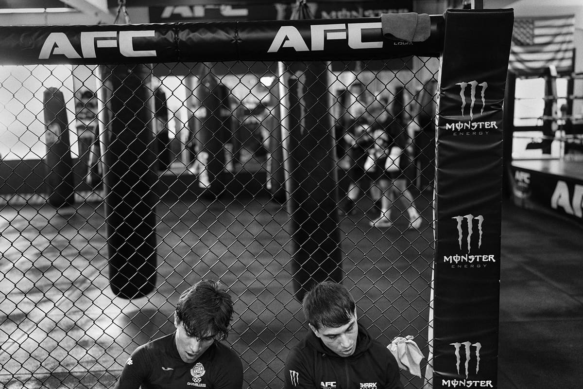 Diego Esteche rests with his brother after a hard training session at an MMA gym in Madrid.