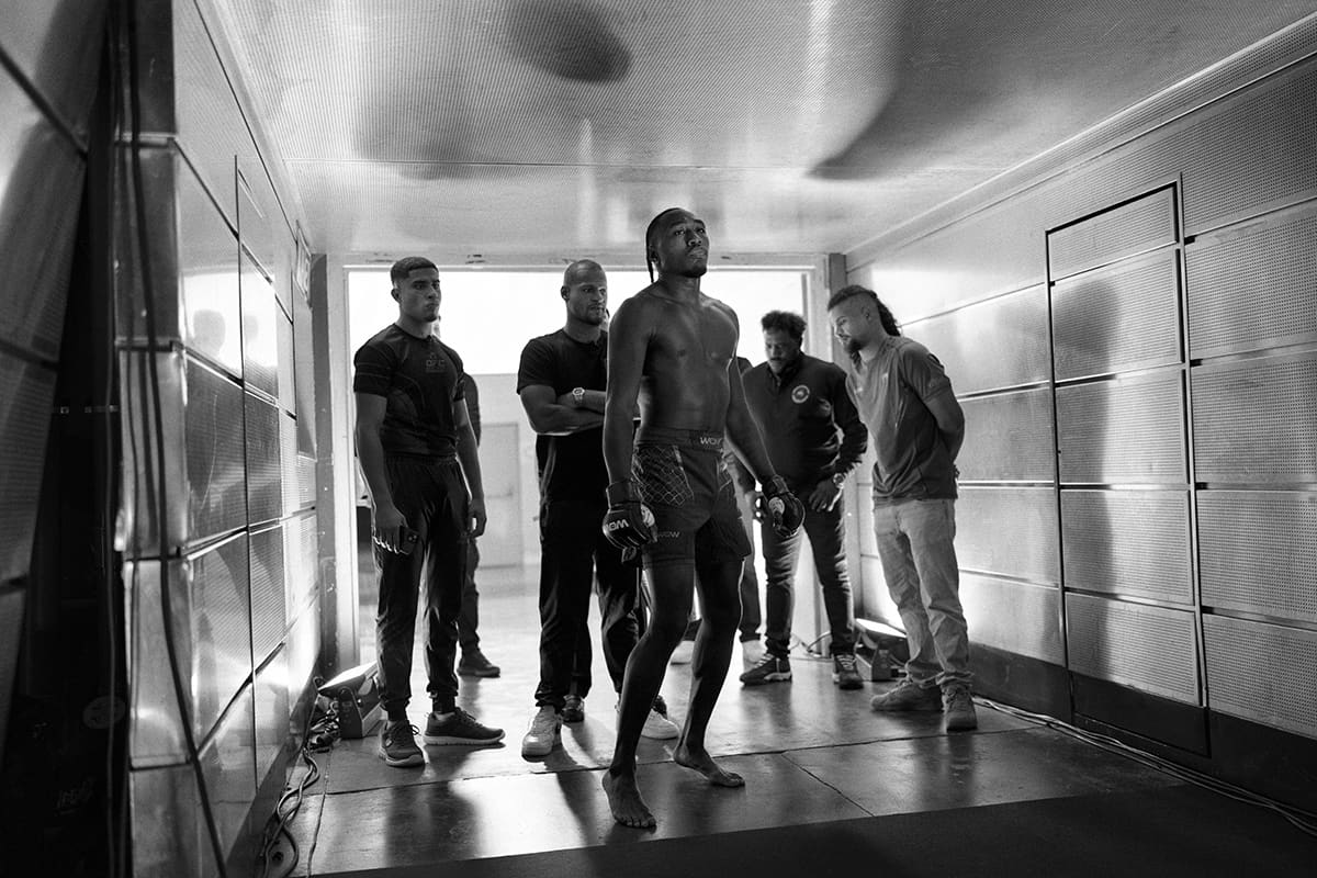 Brian Hooi stands in the entrance tunnel awaiting his lightweight title match at WOW 27 in Madrid's MMA arena.