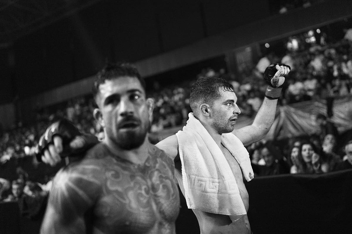 Pablo Colado and Alex Rodriguez salute the crowd after an MMA fight at WOW 26 in Bilbao.