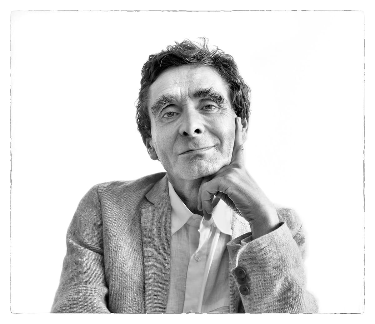 Black and white studio portrait of Adolfo Domínguez, fashion designer, from the series Ñ by Álvaro Ybarra Zavala.