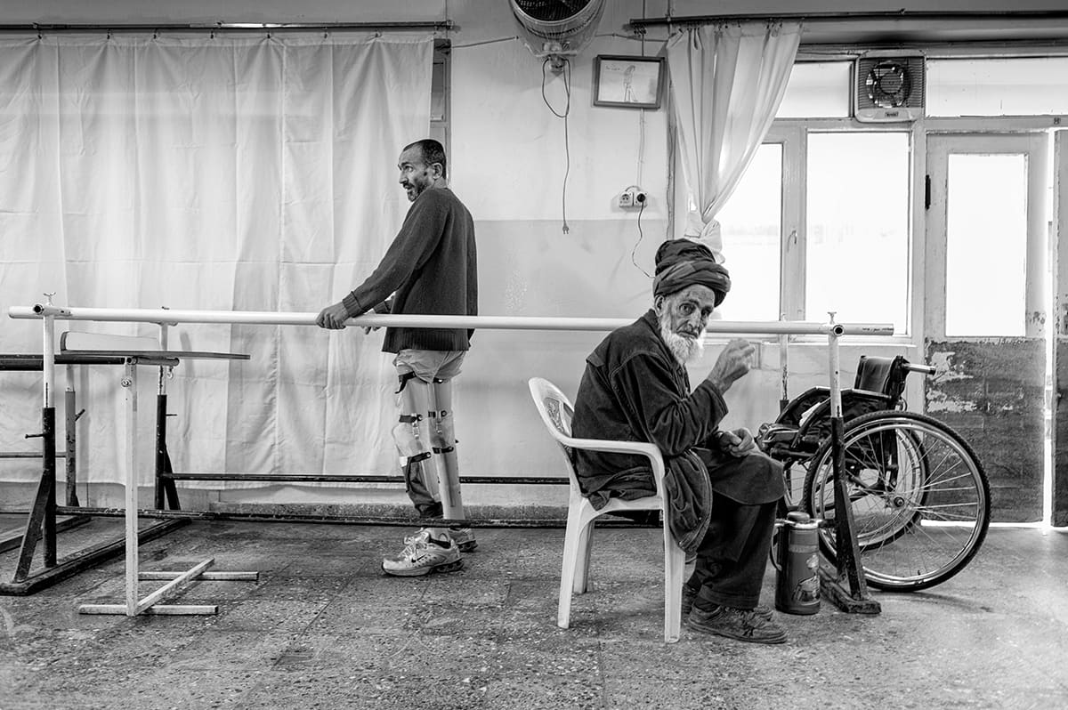 Afghan amputee training between parallel bars at an ICRC orthopaedic centre in Kabul, February 2009