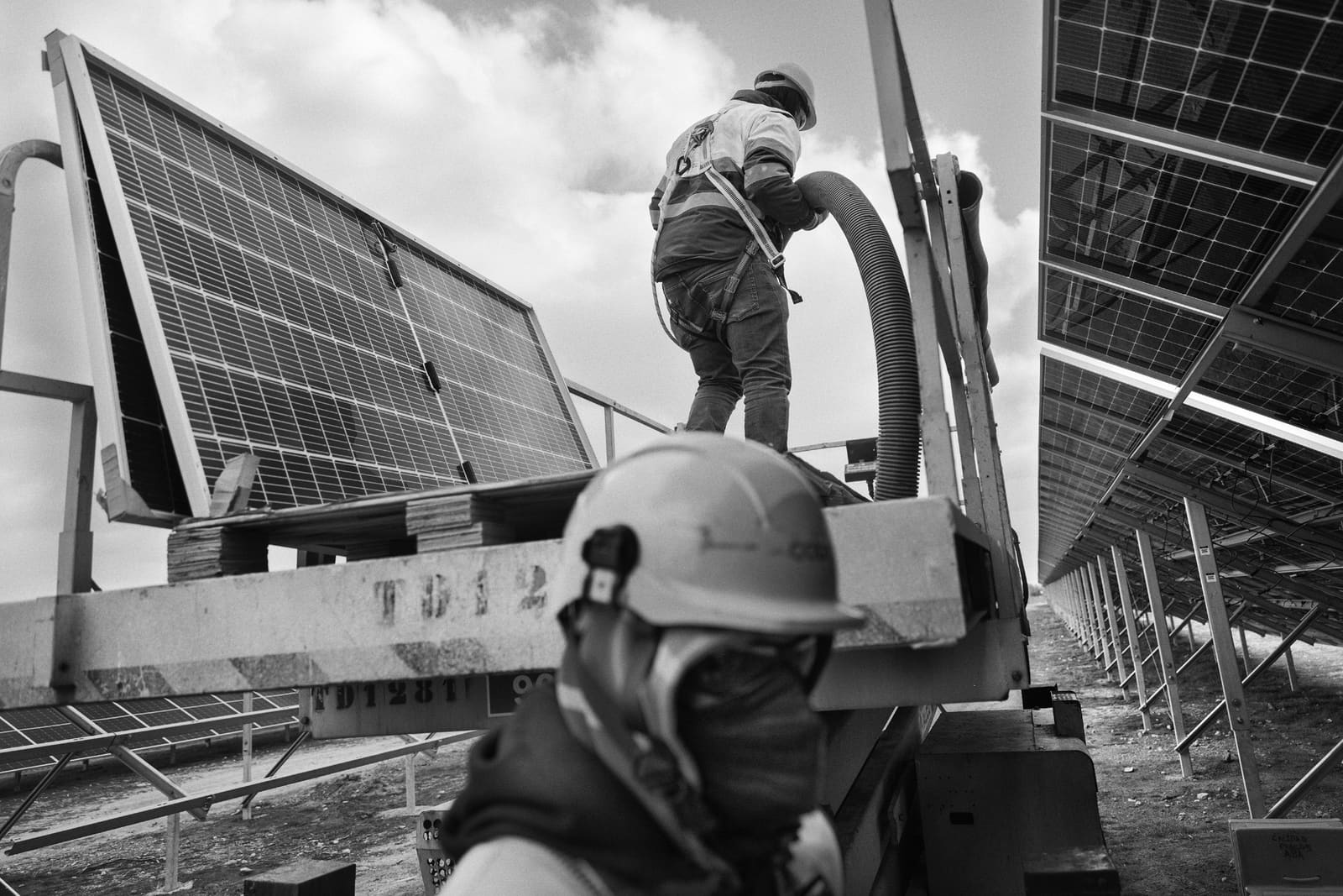 Workers installing photovoltaic panels on the site of the former Andorra power plant, Teruel, Spain, 2023
