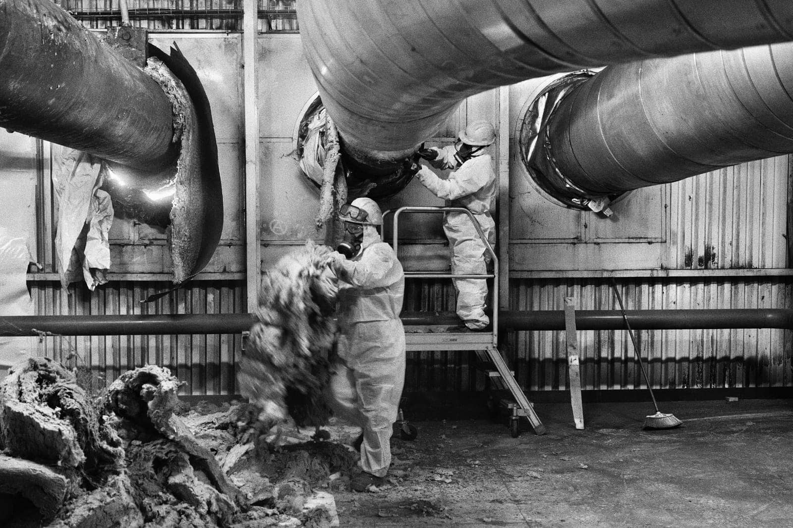 Workers inside a safety enclosure during the dismantling of the Andorra power plant, Teruel, Spain, 2023