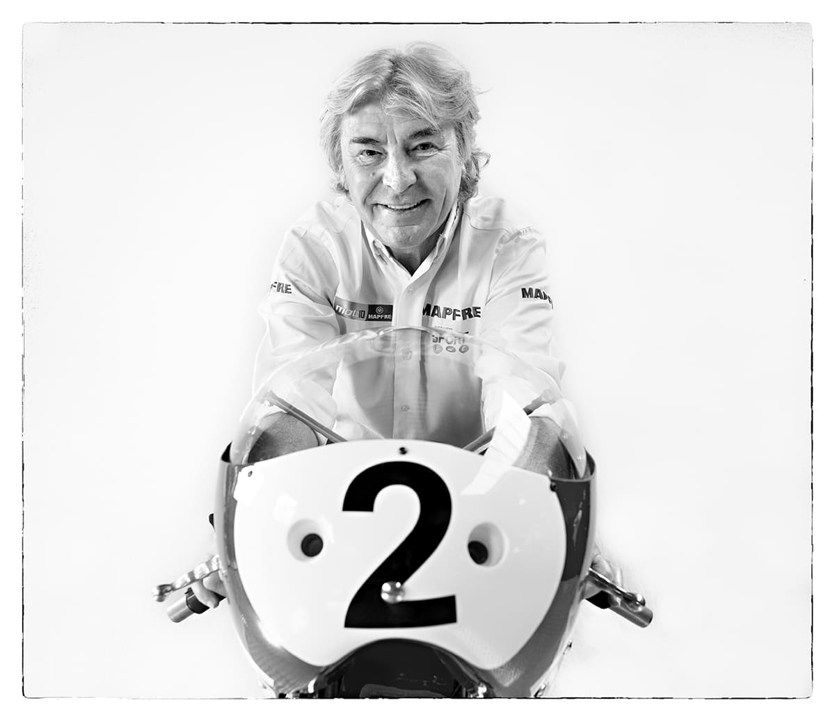 Black and white studio portrait of Ángel Nieto, motorcycling world champion, from the series Ñ by Álvaro Ybarra Zavala.