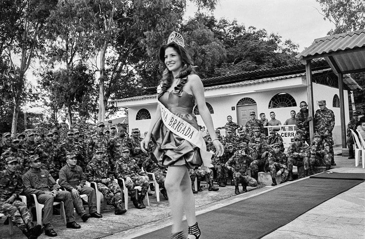 Local beauty queen parades in front of soldiers during a village celebration in rural Huila, 2011