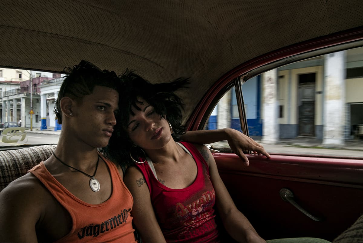 Deinna and Gendris travelling together in the back of a classic American car in Havana.