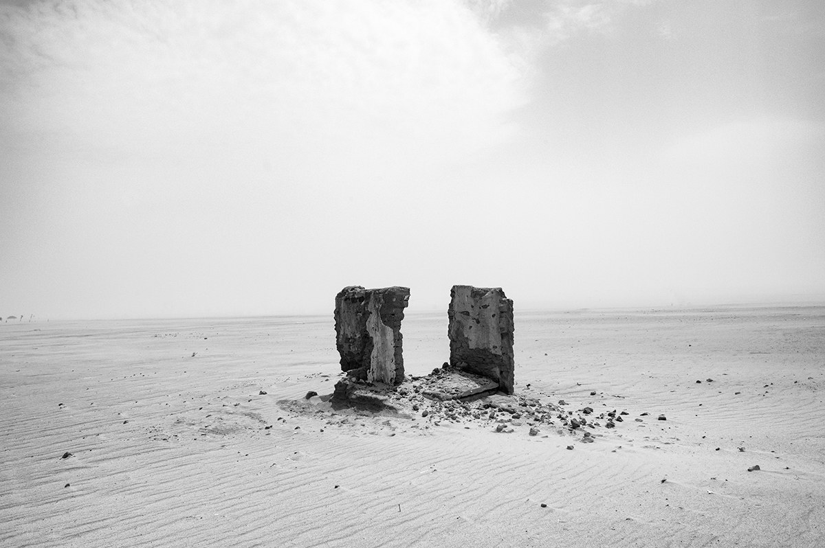 Two remaining walls of a destroyed house in a burned village in the Darfur desert, Sudan.