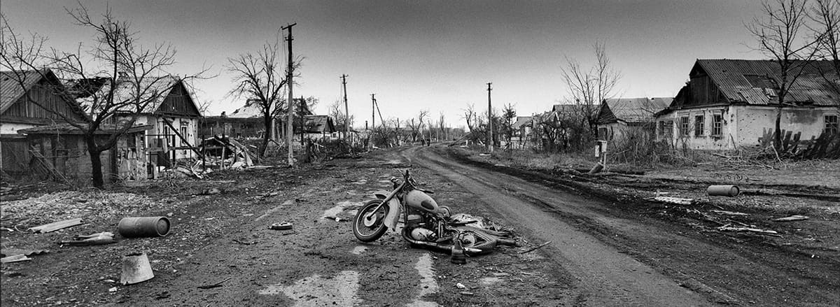 The remains of a motorcycle on the main street of what was once the village of Nikishyne.