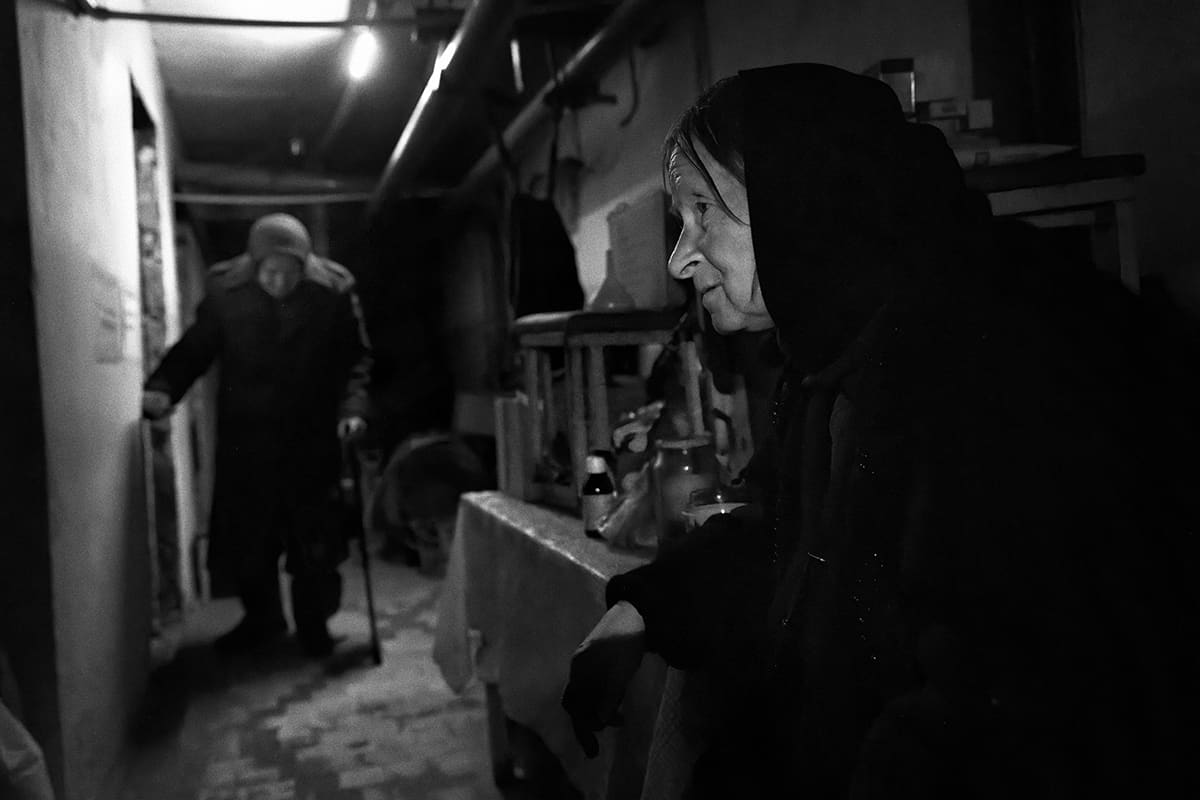 Galina looks up at the ceiling of the basement where she shelters as Russian artillery pounds Siversk.