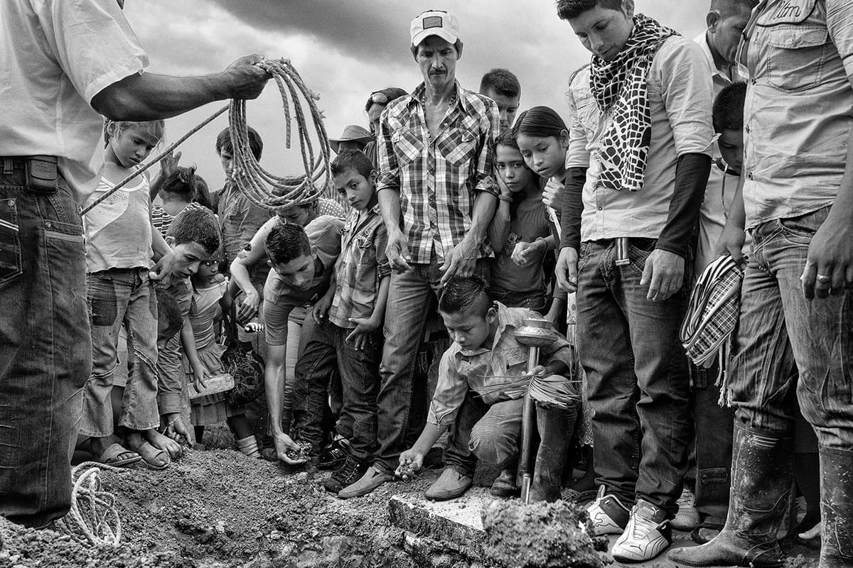 Family and neighbours gather at the funeral of Benjamín in La Unión Peneya, Caquetá, 2013