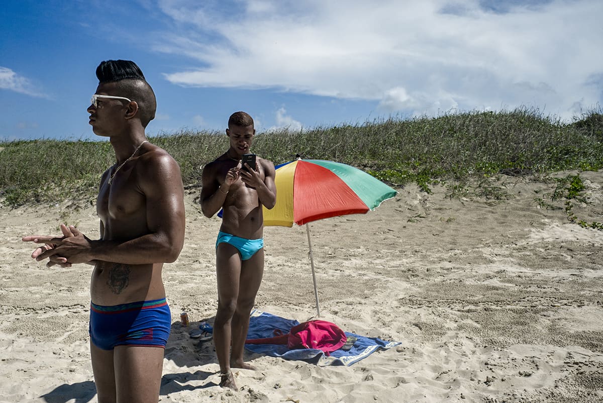 Two gay men resting on Mi Cayito beach, east of Havana, a space of LGBT tolerance in Cuba.