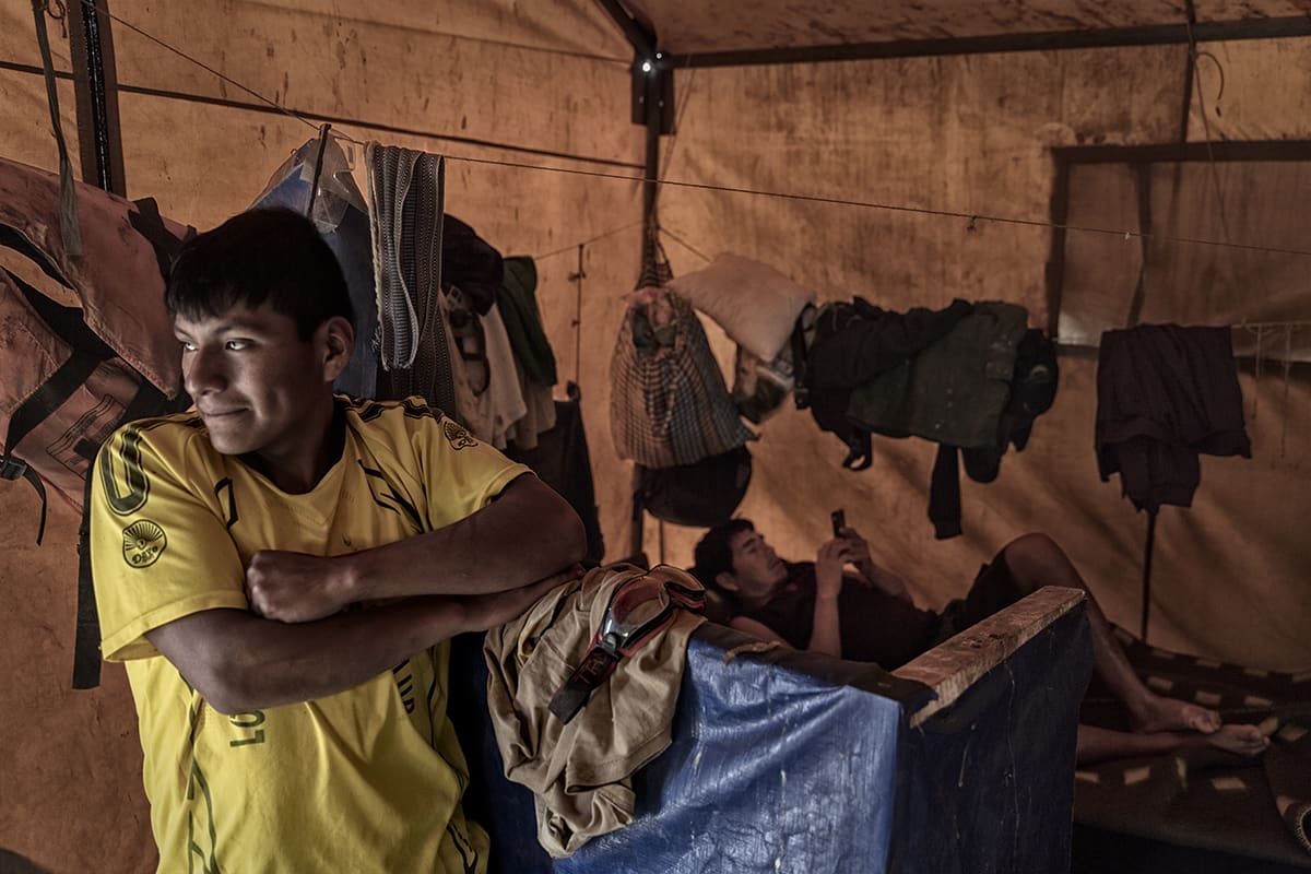Guano workers resting inside a large tent used as accommodation on Isla Asia, Peru.