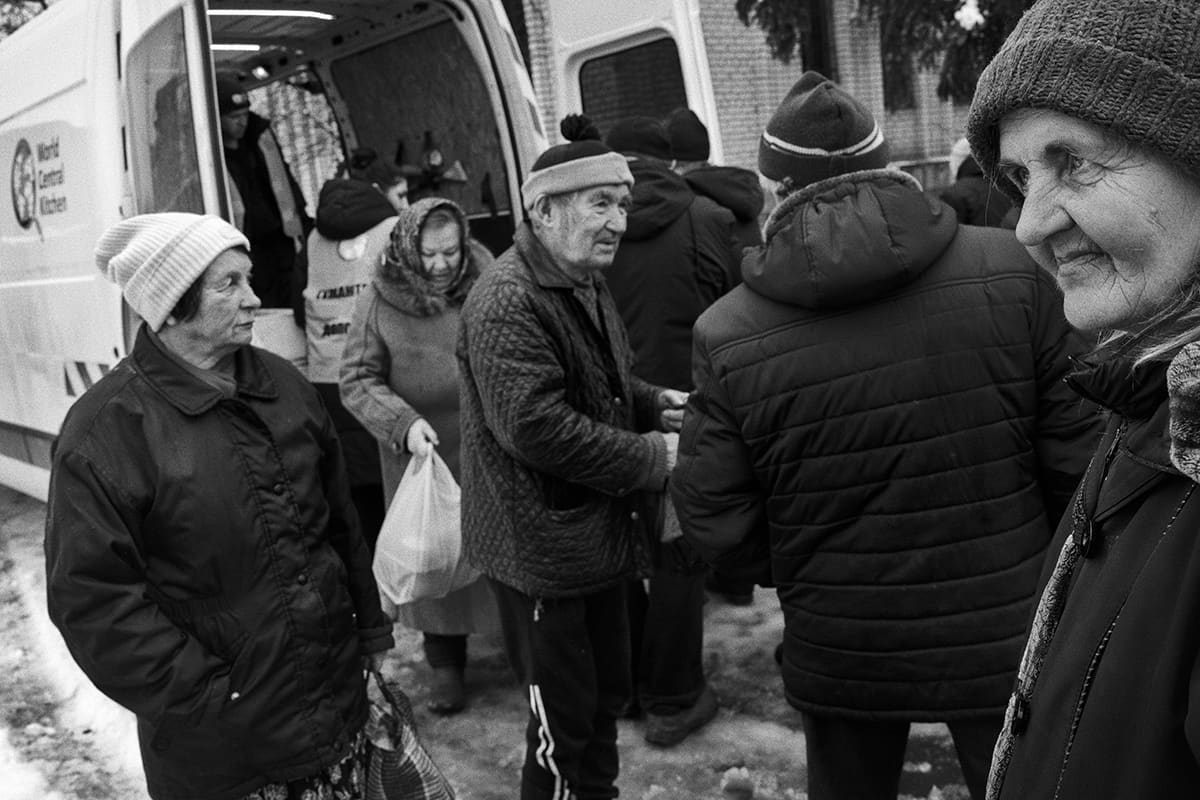 Civilians wait their turn for a food ration from World Central Kitchen in Sviatohirsk.