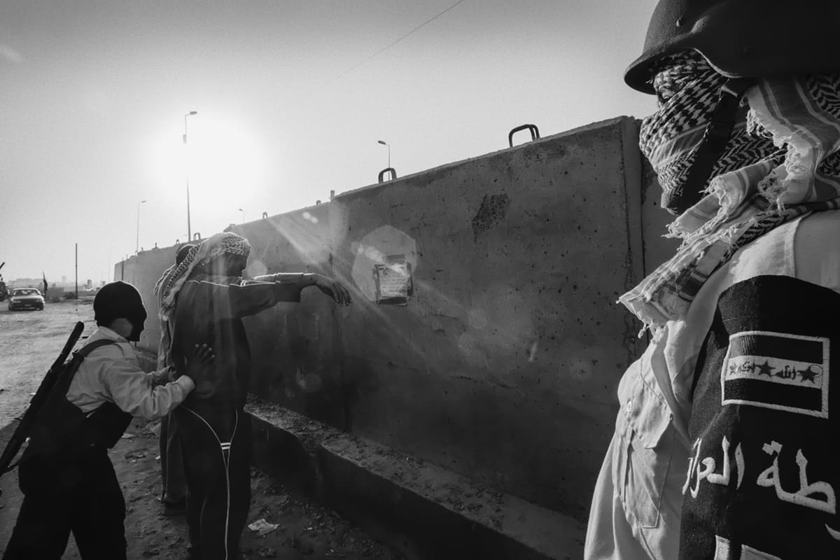 An Iraqi police checkpoint at dawn on the road leading into Ramadi from Baghdad, manned by former Sunni militia members