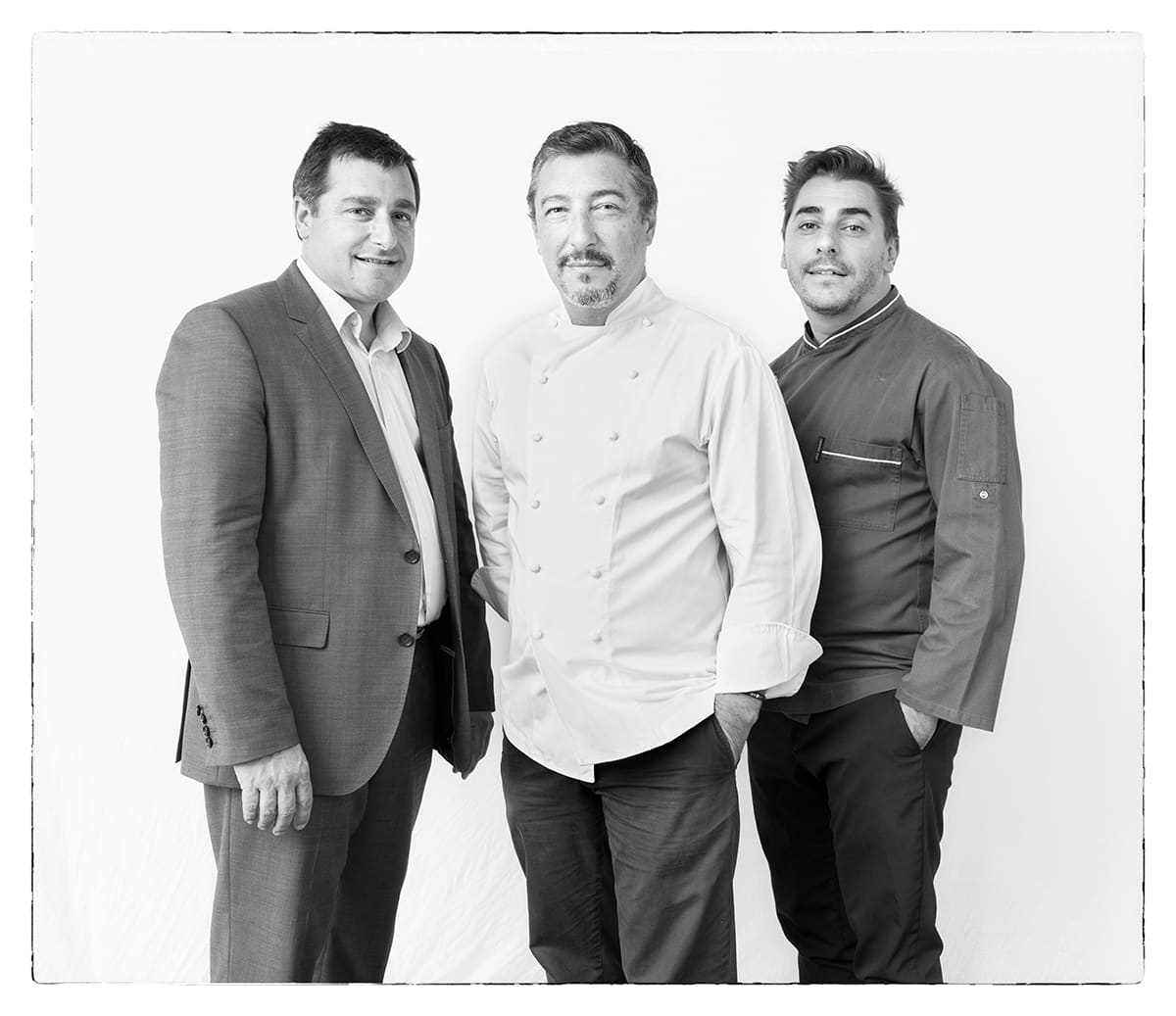 Black and white studio portrait of Joan, Josep and Jordi Roca, chefs, from the series Ñ by Álvaro Ybarra Zavala.