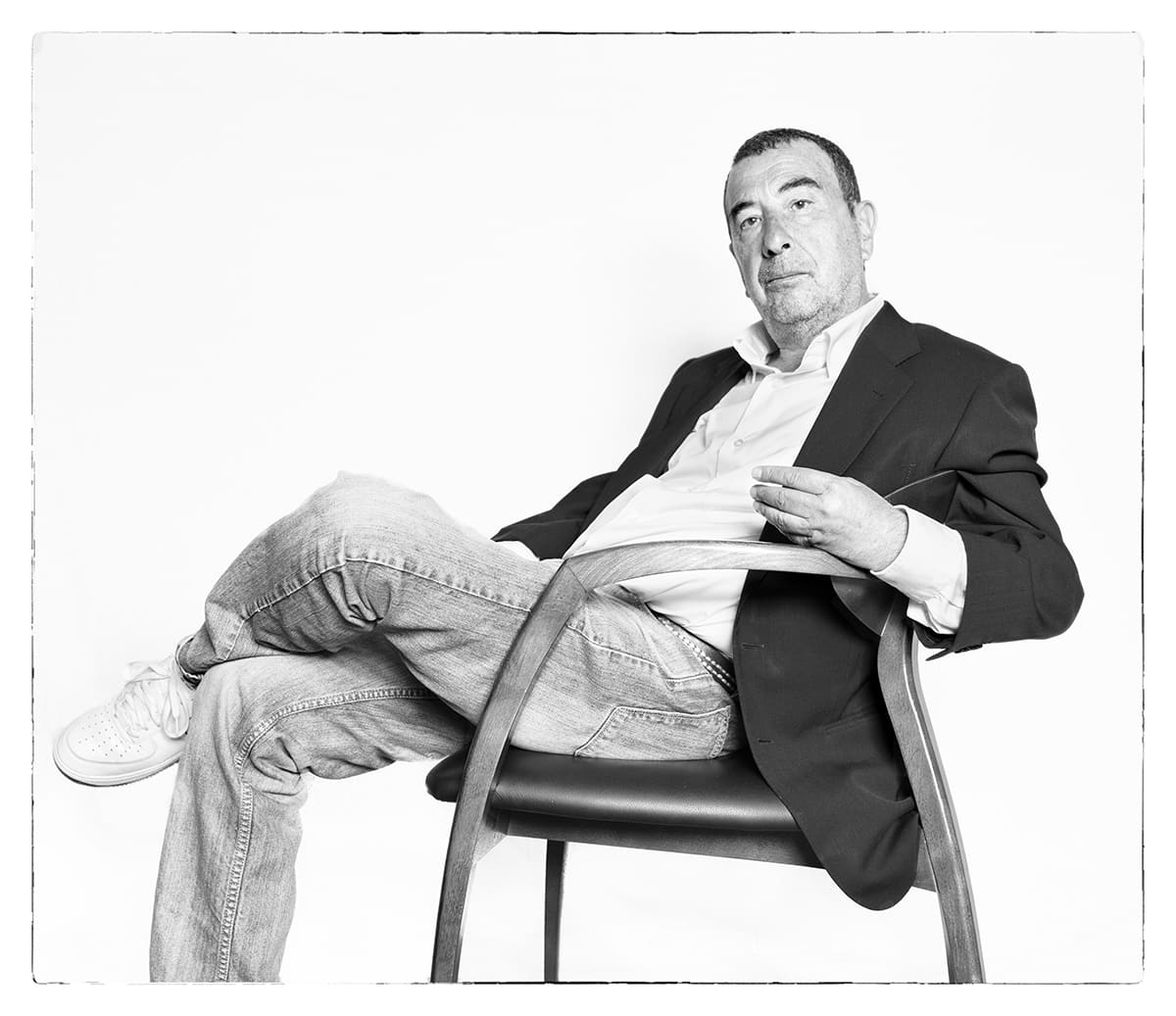 Black and white studio portrait of José Luis Garci, film director, from the series Ñ by Álvaro Ybarra Zavala.