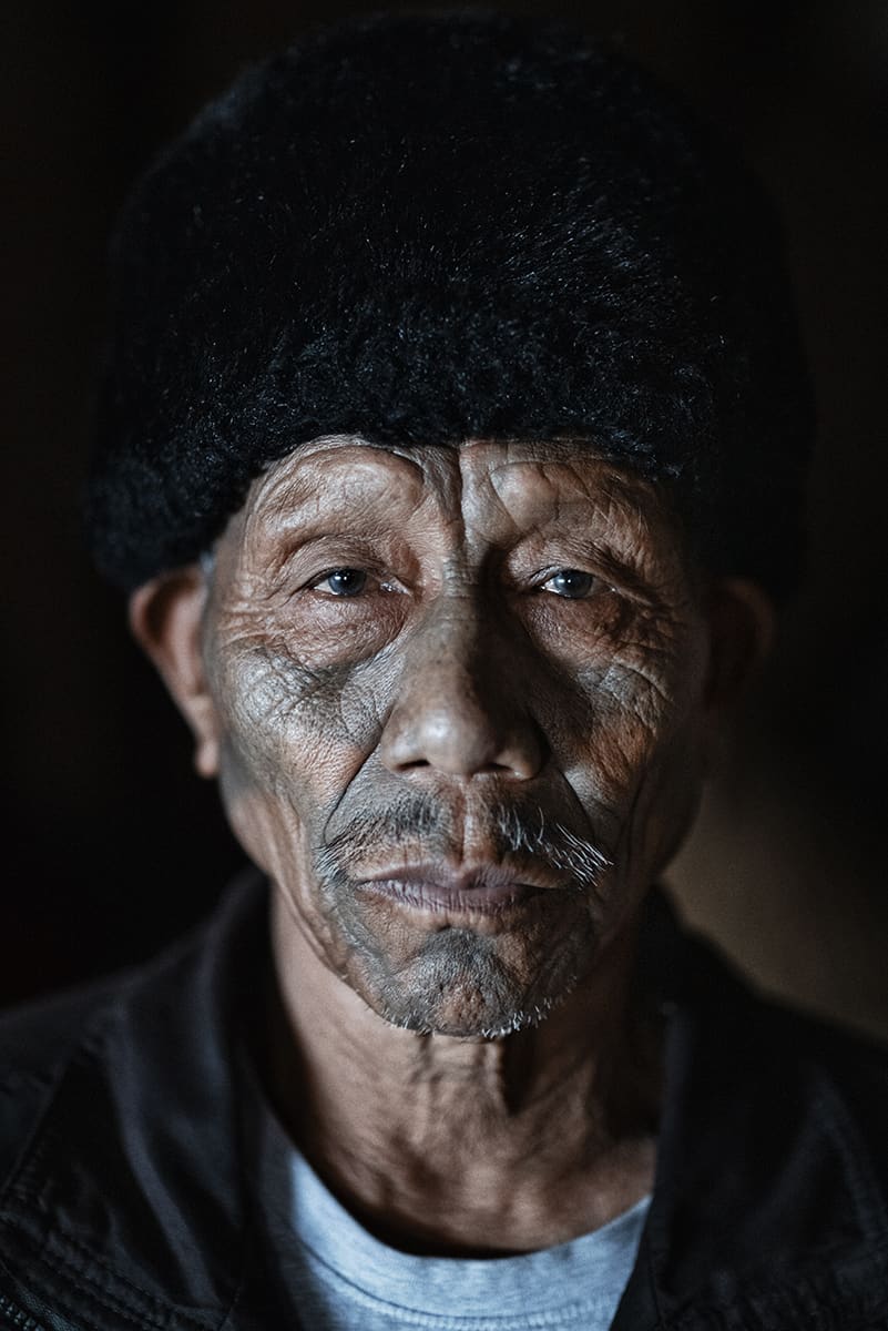 Konyak elder in a black fur cap photographed in his village, Nagaland, India.
