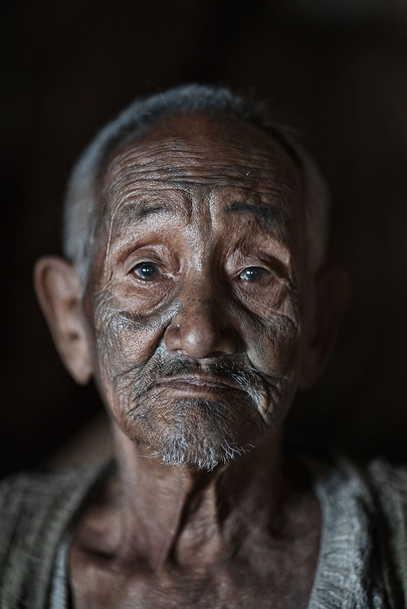Close portrait of a Konyak elder, one of the last tattooed men of Nagaland, India.