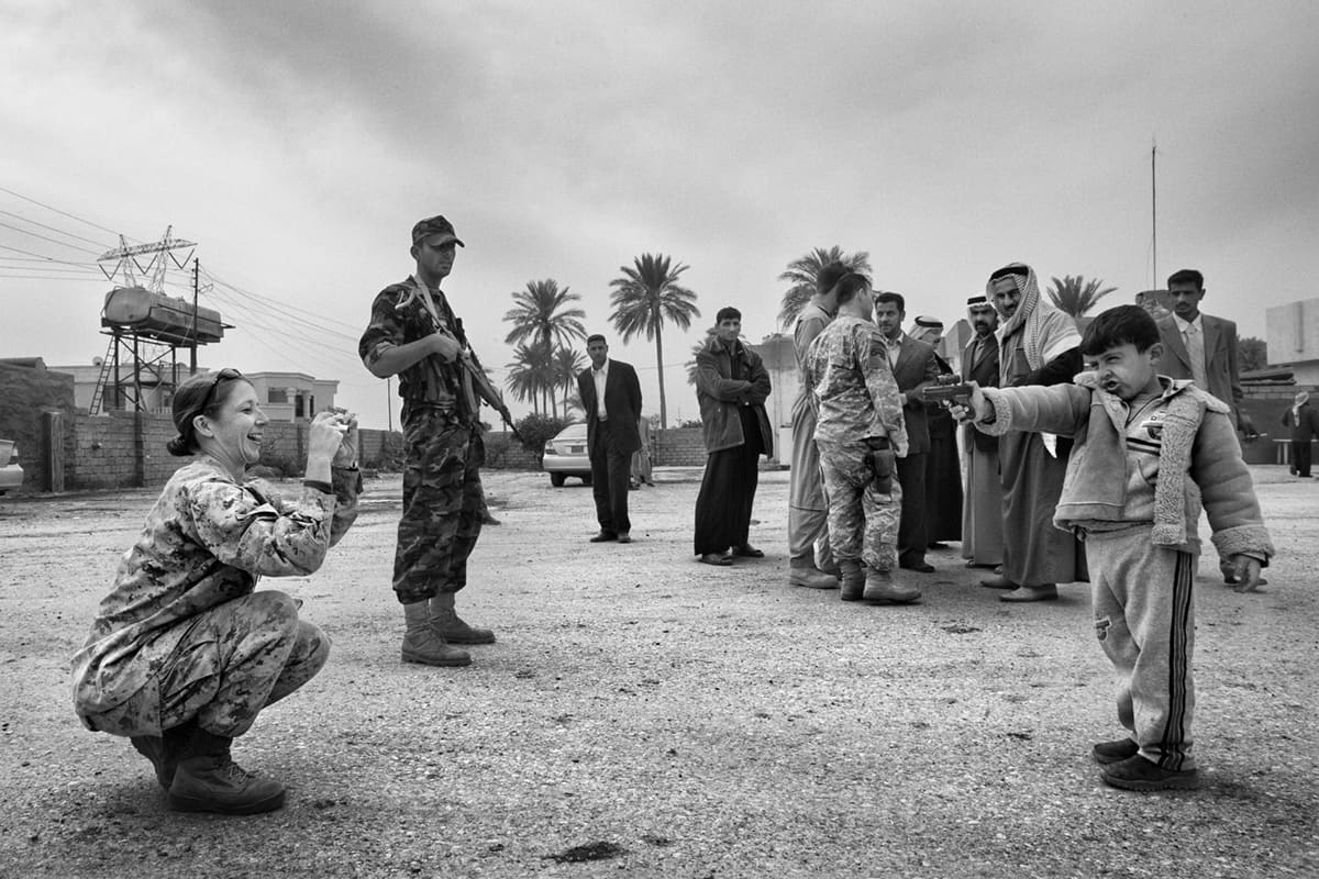 Major Megan McLung photographs the young son of a Sunni tribal leader during the Ramadi insurgency Iraq, hours before her death in an IED ambush