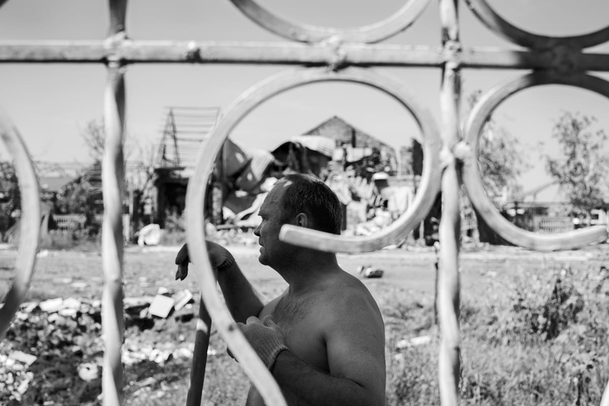 A man works through the rubble of his house after the fighting in Sloviansk.