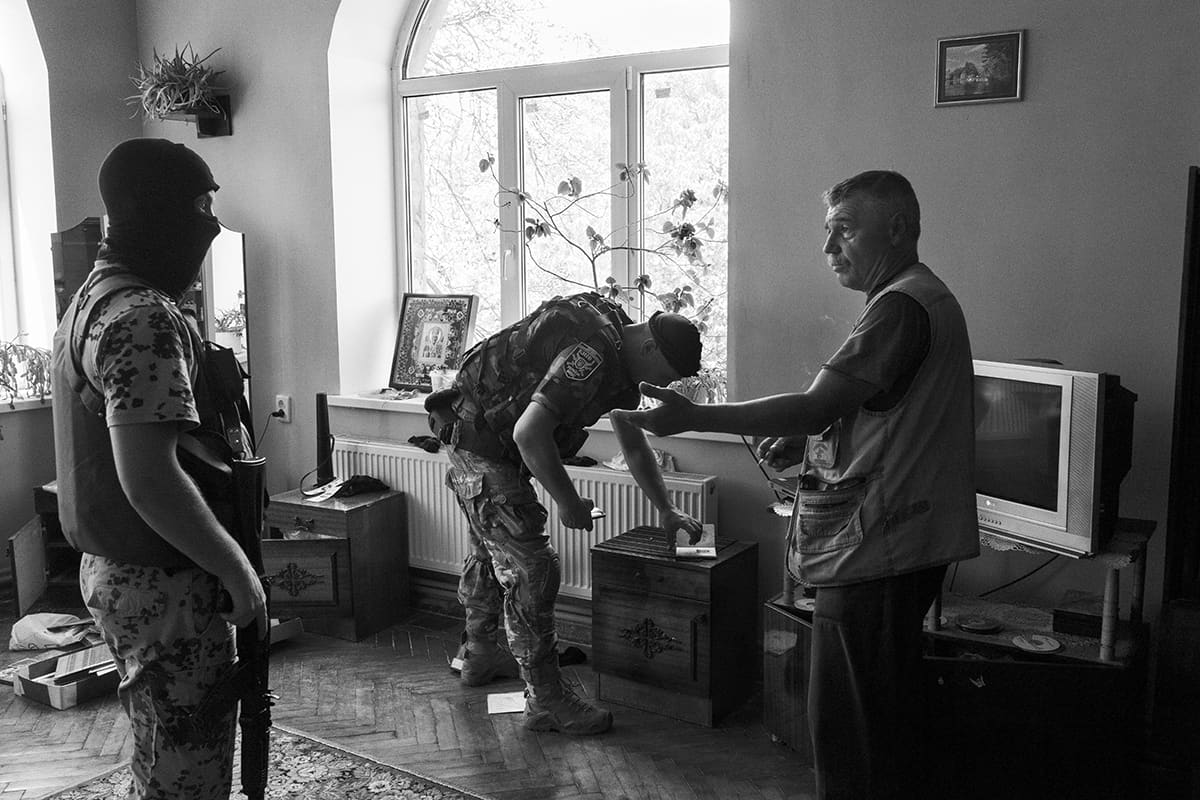 Soldiers of the Kyiv One battalion search a house during an operation against pro-Russian partisans in Sloviansk.