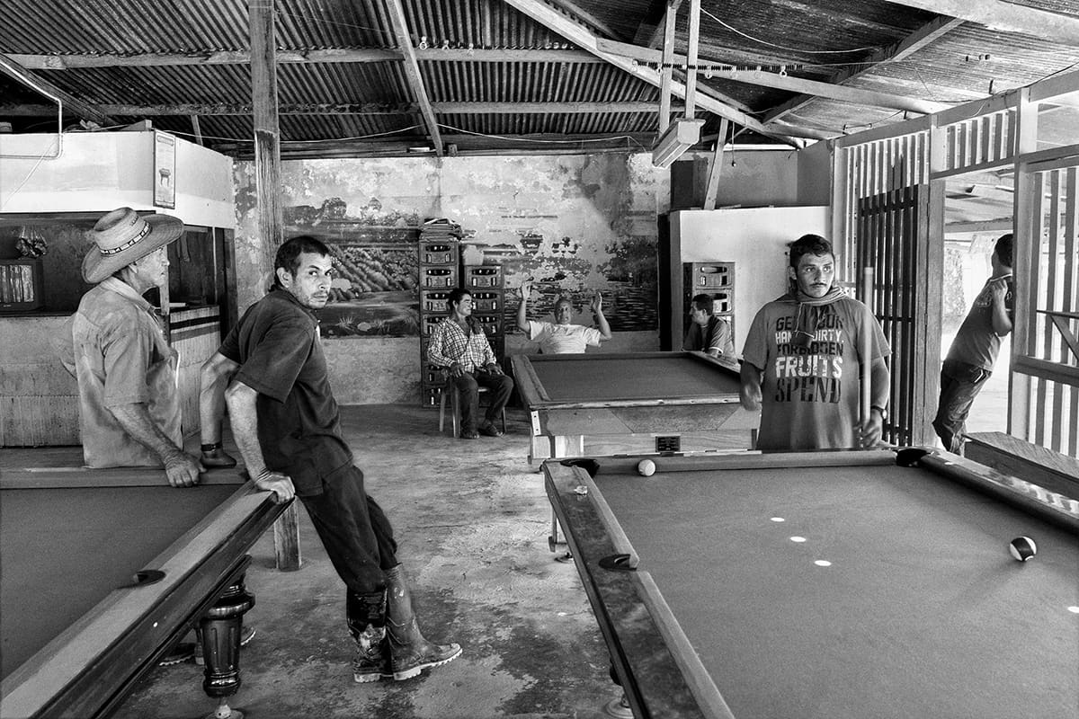 Men play pool in a wooden bar in Santo Domingo, Caquetá, under FARC Bloque Sur influence, 2013