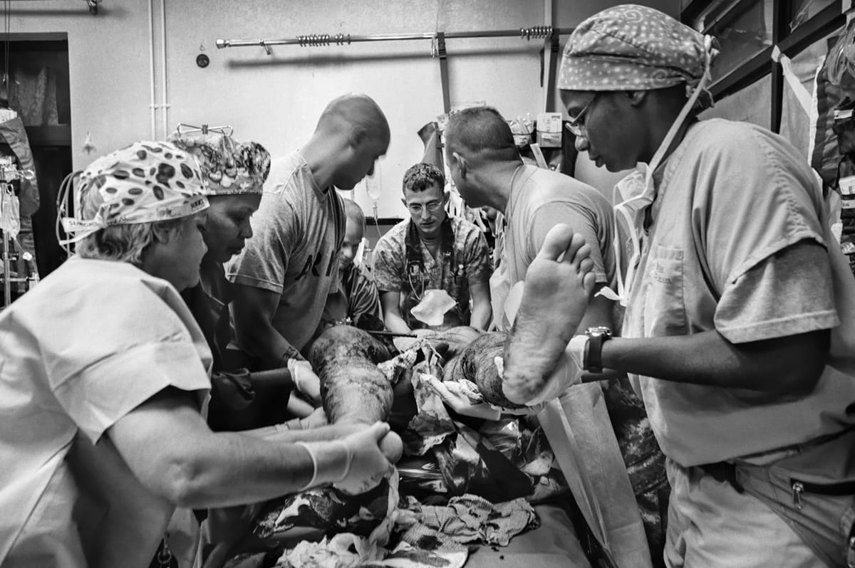 Military doctors and nurses operate on a wounded soldier in the trauma room of the 28th Combat Support Hospital in Baghdad