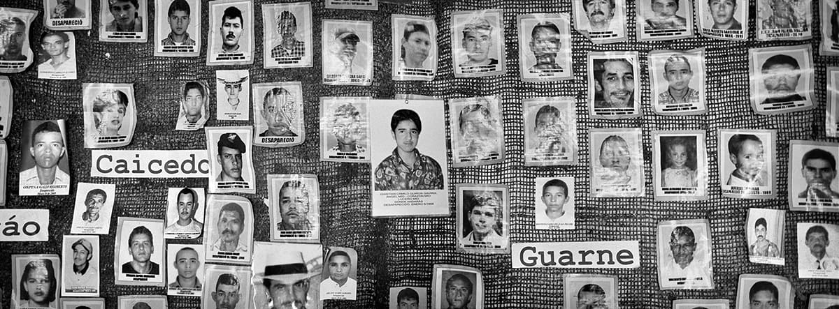 Mural of photographs of disappeared persons in a rural village of eastern Antioquia, 2015