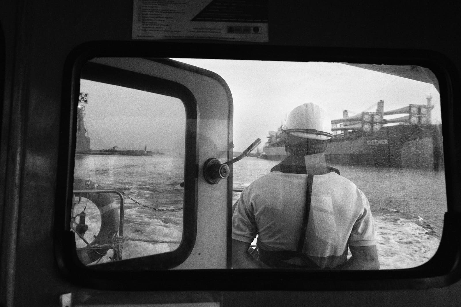 Worker supervising a vessel carrying wind farm components at the Port of Castellón, Spain, 2021