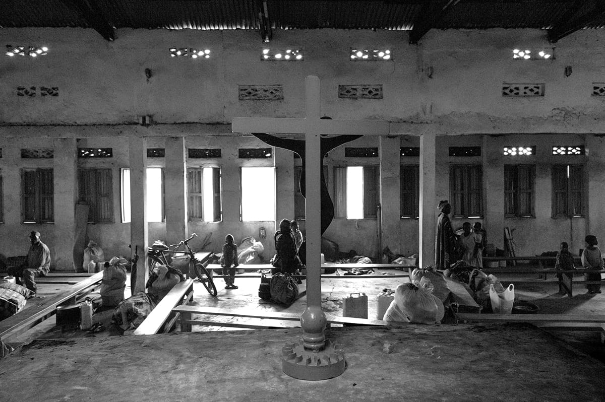 Displaced families sheltering inside an old church in the Kibati refugee camp, North Kivu.