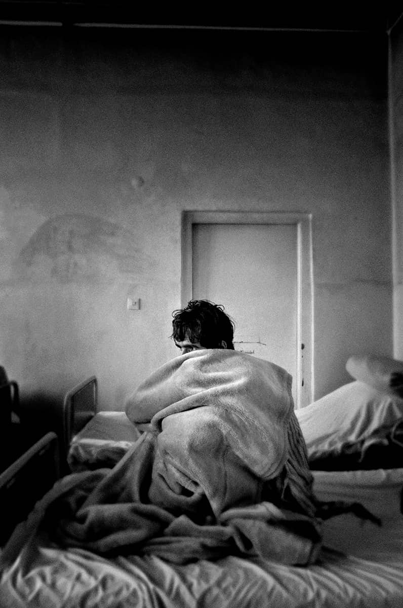 Saigedullah, an Afghan heroin addict, wrapped in a blanket inside Kabul's psychiatric hospital, February 2009