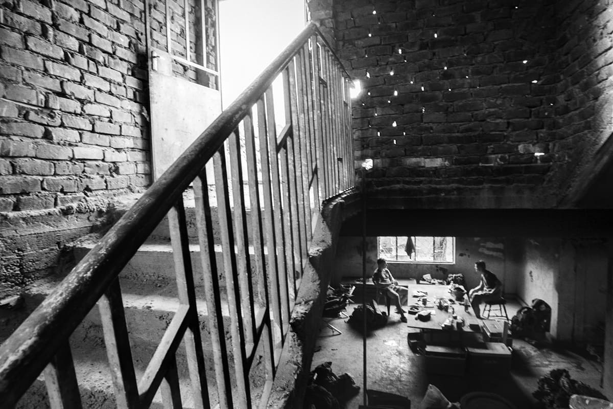 Interior of the destroyed Shoker base in Fallujah during the Fallujah battle Iraq, with US Marines resting below a damaged staircase