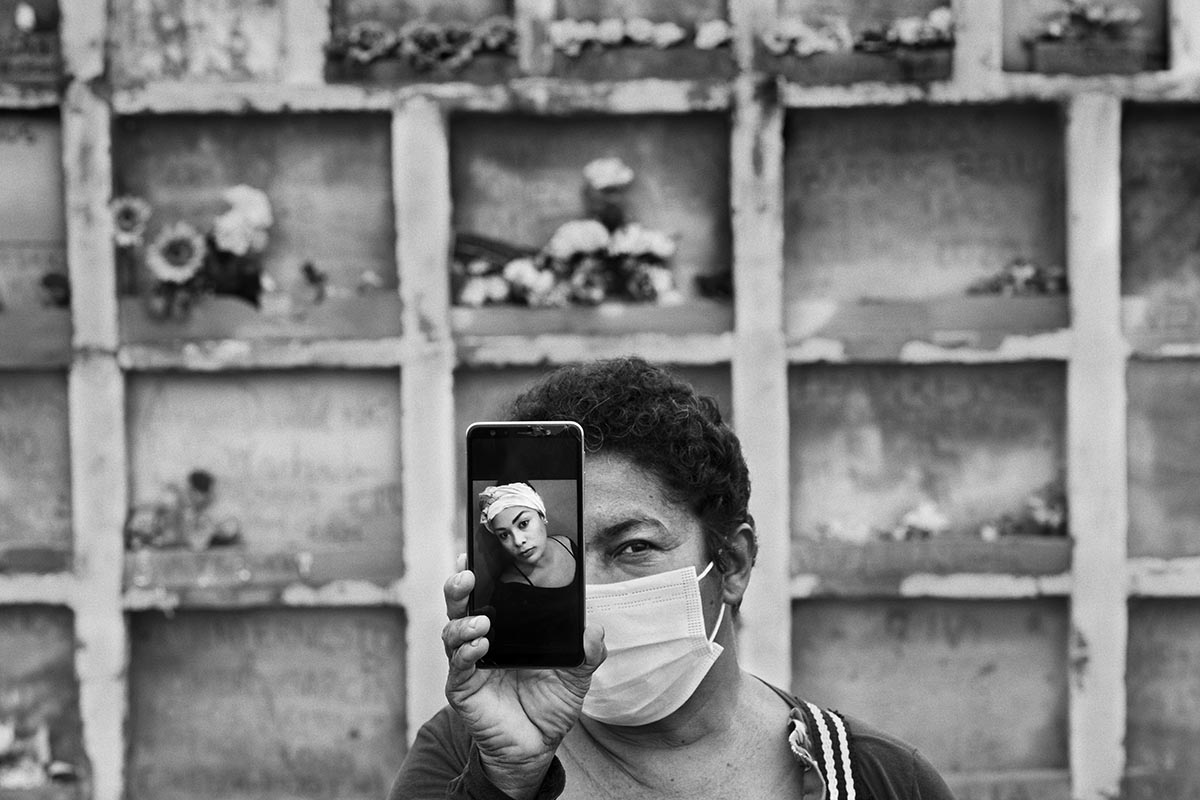 Sista Velázquez holds a portrait of Vicmar Gómez Reyes, a Venezuelan migrant who died after giving birth