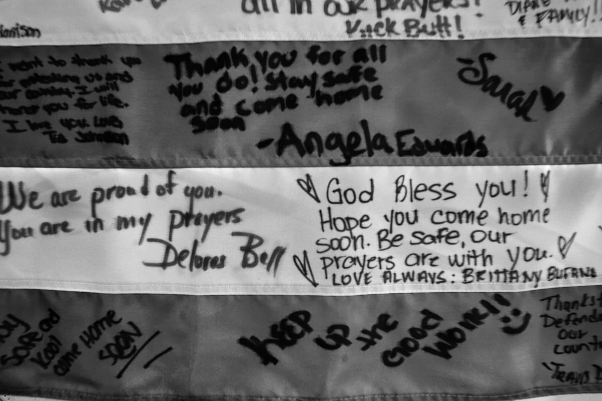 A US flag covered in handwritten messages of support hangs on a wall of the 28th Combat Support Hospital, 'China Dragon', in Baghdad