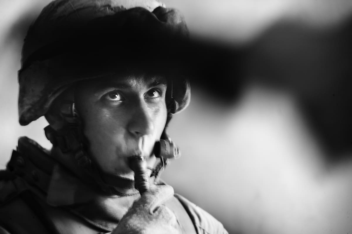 A US Marine from Bravo Company drinks from his CamelBak hydration pack during a brief pause in a patrol in Fallujah