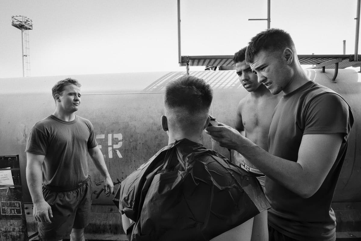 US Marines from Bravo Company taking turns cutting each other's hair during free time at the Shoker base in Fallujah