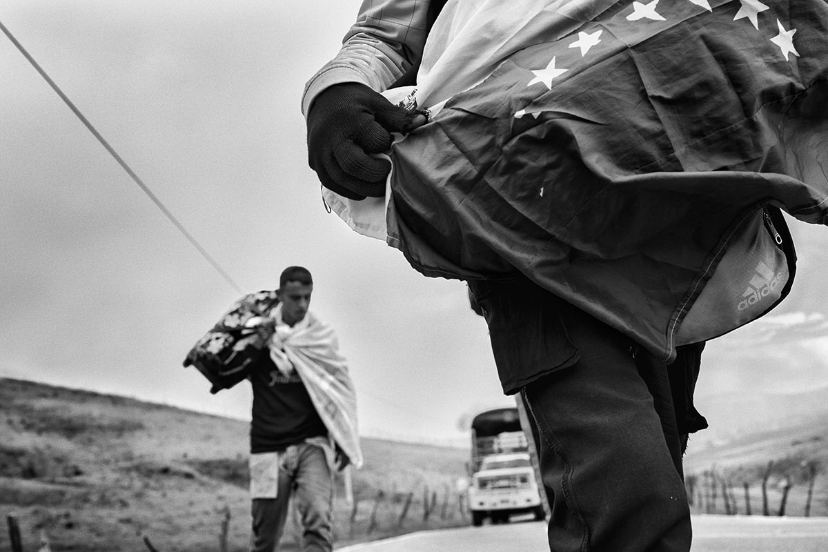 Venezuelan migrants walk toward Bogotá after crossing into Colombia at Cúcuta