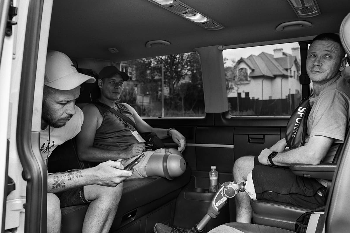 Herman, Volodymyr and Timur wait in the minibus that takes them home from the rehabilitation centre.