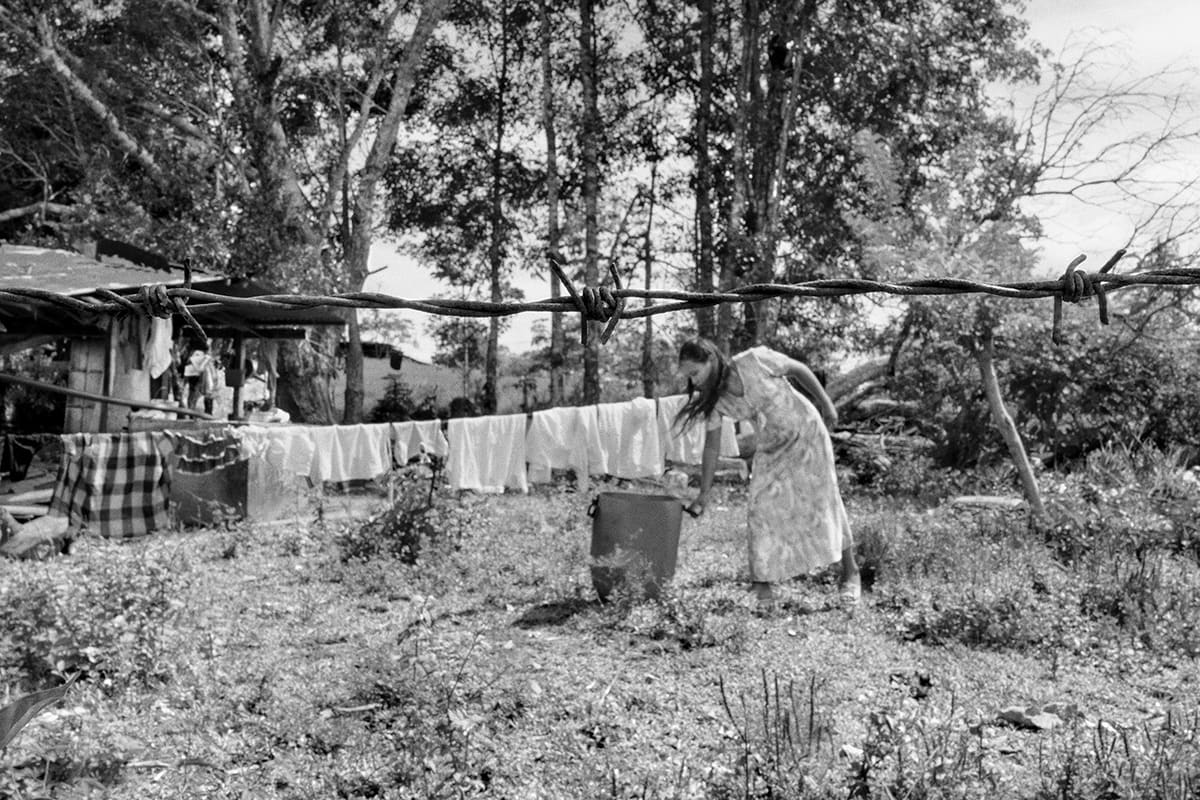 Woman hangs laundry in her garden in Santo Domingo, on the Caguán River, FARC Southern Bloc territory, Caquetá, 2013