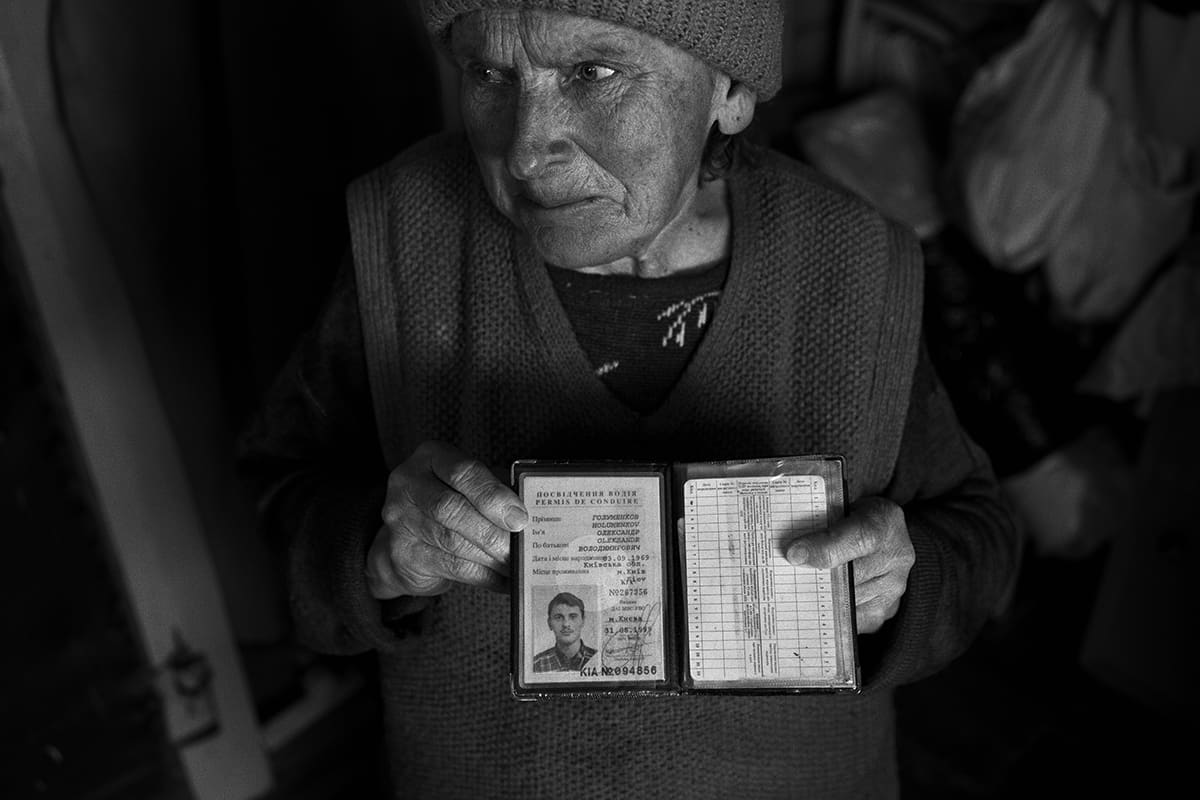 A woman weeps as she reports the disappearance of her husband and son after the liberation of Irpin.