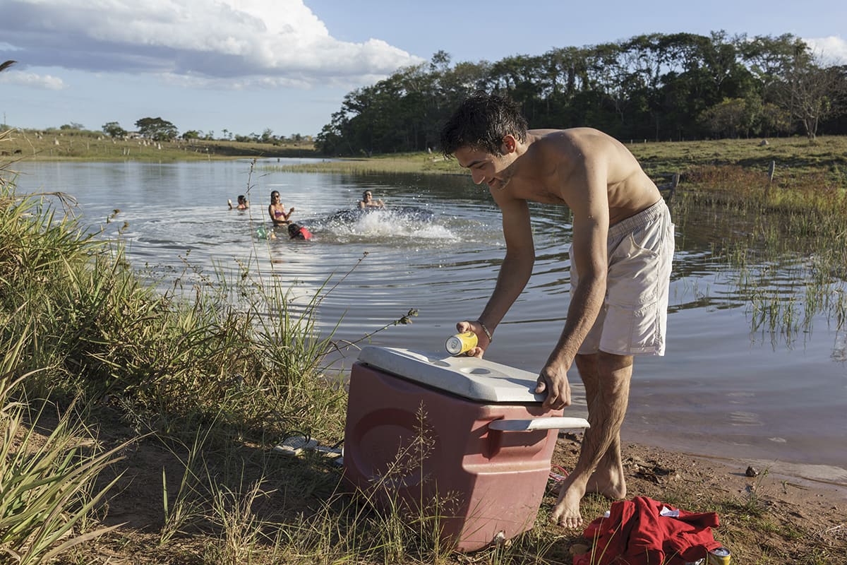 Young people gathering near a small lagoon in the community of Sipo