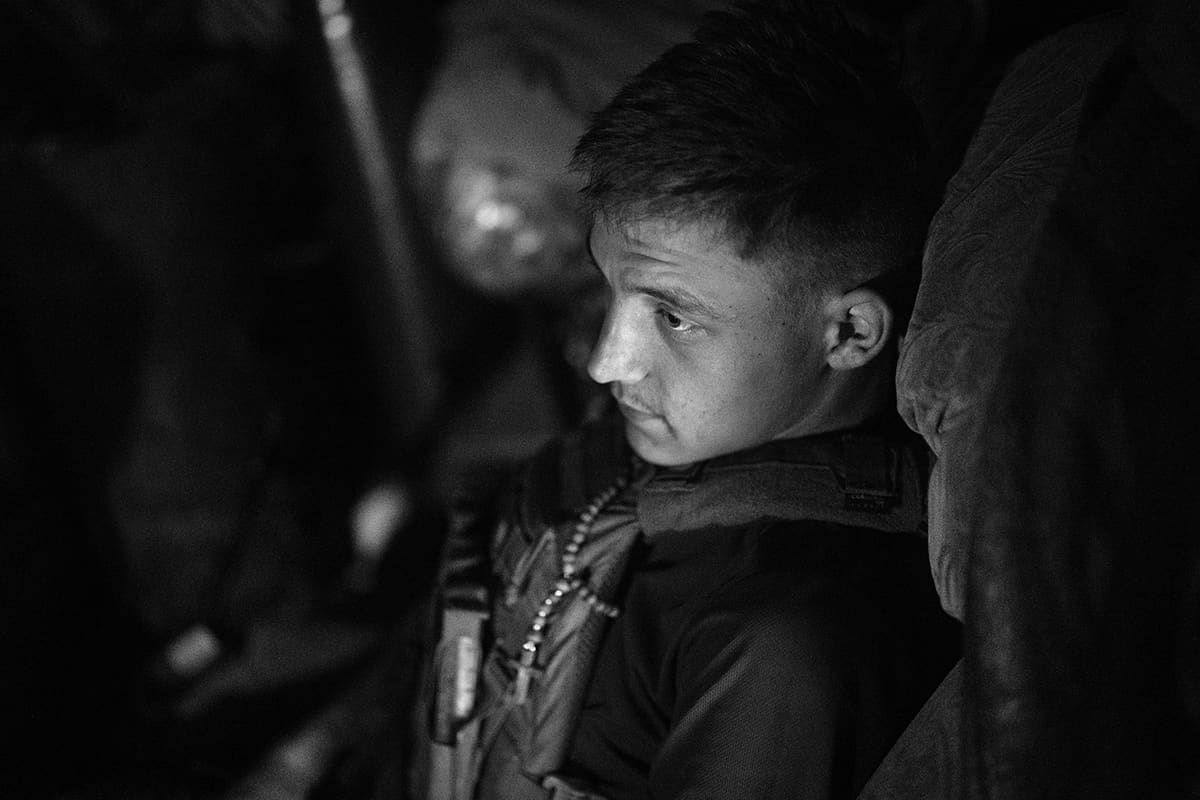 A soldier of the 80th Brigade takes cover inside a bunker during a Russian artillery bombardment.